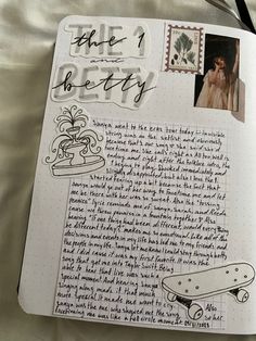 an open notebook with writing and pictures on it