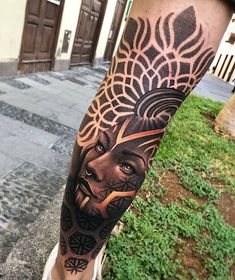 a man's leg with a tattoo on it and an image of a lion