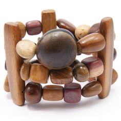 "Unisex wooden bracelet handmade by artisan hands under the tropical rainforest in Costa Rica.  Connect to Mother Nature by wearing its natural warmth and beauty in rainforest woods. This unique bracelet is handmade with different types of sustainably sourced tropical woods such as rosewood, tigerwood, fustic and purpleheart. Each bead is polished and lacquered to uncover its characteristic grain and color, displaying its natural beauty. Name: Multicolor geo shapes cuff bracelet Length: 9.4\" inches (23.9cm) Width: 2.25 inches (5.72cm)   Color tone and grain varies in natural woods EE1907" Artisan Brown Beaded Bracelet With Wooden Beads, Artisan Brown Beaded Bracelets With Wooden Beads, Artisan Brown Wooden Beads Bracelet, Artisan Brown Wooden Beaded Bracelets, Handmade Beaded Wood Bracelets In Natural Wood Color, Natural Wooden Beads Bracelet, Bohemian Wood Bracelet Jewelry, Handmade Adjustable Beaded Bracelets In Natural Wood, Artisan Brown Bracelet With Wooden Beads