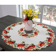 a white table with red and yellow flowers on it