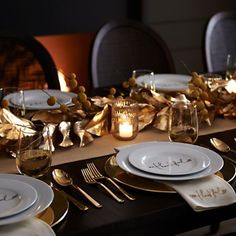 the table is set with gold and white plates