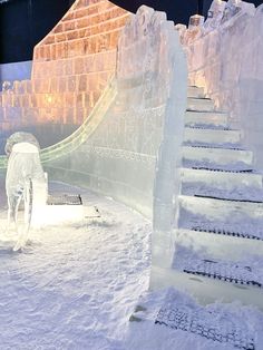 an ice sculpture in the shape of stairs and steps leading up to a snow covered building