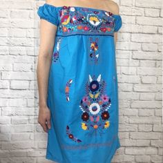 Size: Medium (See Measurements Below) Color: Sky Blue Dress With Multi-Colored Floral Embroidery This Is A Beautiful Handmade Dress From Oaxaca, Mexico. Material: Poplin Cotton Blend This Dress Is Light, Flowing & May Require A Slip Or Camisole Underneath. Measurements (Approximate): Length: 32 Inches Bust: 34 - 36 Inches Sky Blue Dress, Mexican Home Decor, Fiesta Decorations, Mexican Dress, Mexican Dresses, Handmade Dress, Handmade Dresses, Blue Dress, Floral Embroidery