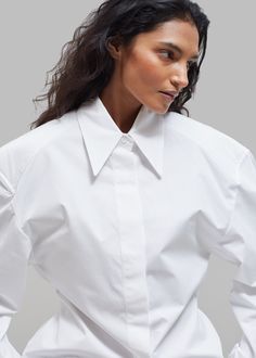 Color: White Lightweight cotton woven fabric Oversized silhouette Pointed collar Lightly padded shoulders Curved hem Adjustable fabric ties on sides Button cuffs Concealed front button closure Unlined 100% Cotton Dry Clean Imported The Frankie Shop, Frankie Shop, Oversized Silhouette, Cotton Weaving, Woven Fabric, Color White, Collar, Fabric, How To Wear