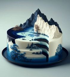 a blue and white cake with mountains on it