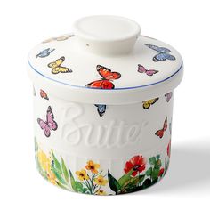 a white canister with colorful butterflies and flowers painted on the side that says butter