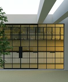 an empty room with glass doors and trees