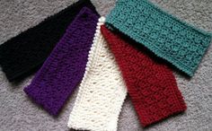 four crocheted headbands laying on the floor