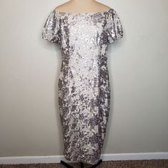 This Dress Is A Stunning Gol Metallic Dress That Could Be Worn For Many Different Occasions! It Could Be Worn As Wedding Guest , Mother Of The Bride/ Or Groom, Also Baptism, Or Party, Bridesmaid Many Many Different Occasions! This Is A Can’t Miss Dress ! Questions? Leave A Comment Below! Elegant Short Sleeve Dresses For Celebration, Silver Sequin Dress For Celebration, Silver Sequin Celebration Dress, Metallic Silver Sequin Holiday Dress, Holiday Sequin Metallic Silver Dress, Holiday Metallic Silver Sequin Dress, Festive Silver Dress For Celebration, Festive Silver Celebration Dress, Elegant Metallic Sequin Dress For Festive Occasions