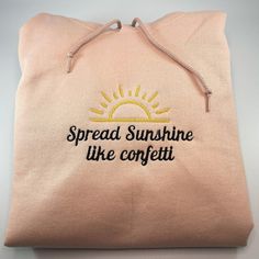 a pink bag with the words spread sunshine like confetti on it's side