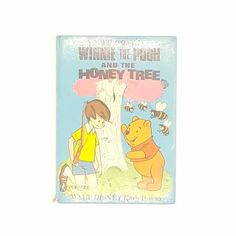 the winnie the pooh and the honey tree book is shown in front of a white background