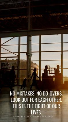 people are walking through an airport terminal with the sun setting in the window behind them