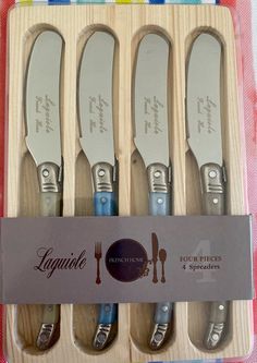 four knives and forks in a box with the label lagnite restaurant & steakery