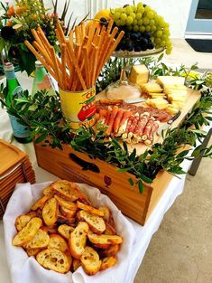 a table topped with lots of different types of food on top of a wooden box