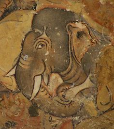 an elephant painted on the side of a rock wall with other animals around it and another animal in the foreground