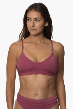 The Mara gives you the perfect hybrid sports bra + bikini top to wear for hot yoga or during a hard swim practice. Designed as a supportive bikini sports bra for athletes - the Mara can be worn at the gym or in the water. The cut out strappy detailing on the back and scooped neckline make it a flattering full coverage sports bra option. Features: Good for: Yoga, Beach Volleyball, Swim, Water Polo, Surfing, paddling, lifeguarding, ocean activities, pool activities, gym workouts Fixed-back straps T-back Sports Bra For Pilates, Triangle Top Sports Bra With Removable Pads, Seamless Triangle Top Sports Bra, Sports Bra With Removable Pads And T-back, Sporty Bra With Removable Pads For Pilates, Sporty Workout Swimwear Bra Friendly, Athleisure Swimwear With Removable Bra Pads For Workout, Stretch Sports Bra With Padded Cups For Yoga, T-back Sports Bra With Removable Pads For Gym