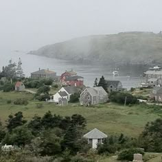 a foggy day in a small town by the water