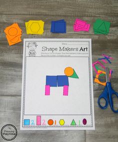 the shape makers art project is displayed on a wooden table with scissors and construction paper