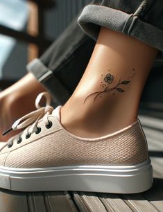 a woman's foot with a small flower tattoo on her left side ribcage