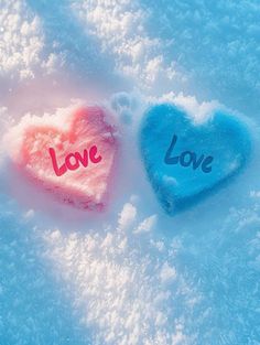 two hearts in the snow with love written on them