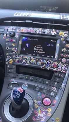 the interior of a car with stickers on it's dash board and steering wheel