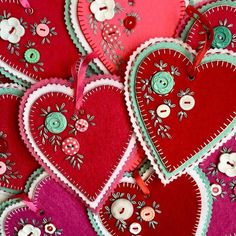 several red and pink hearts with buttons on them