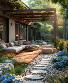 an outdoor living area with flowers and rocks