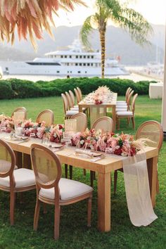 a long table with chairs and flowers on it