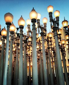 many street lamps are lit up in the evening