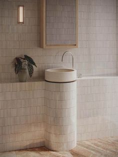 a white sink sitting under a bathroom mirror next to a bathtub and toilet paper dispenser