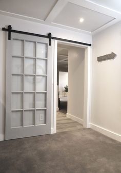 an empty room with a sliding door and carpeted floor