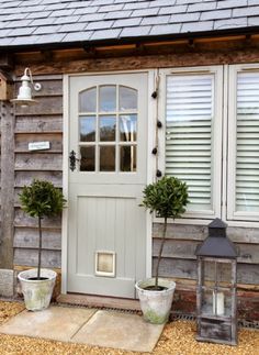 an instagramted photo of a house with two potted plants on the front porch