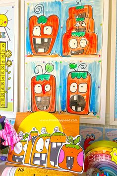 children's artwork is displayed on the wall in front of other art pieces and toys