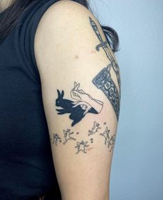 a woman with a black and white tattoo on her arm