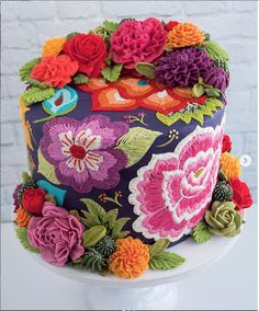 a multicolored cake with flowers on it