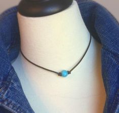 There is something about the calmness of blue turquoise howlite that bonds with the Naturalist Soul that wears it. Very high quality, blue lustrous bead sits center on genuine leather cording. A single freshwater pearl is used on back of necklace as a sliding knot clasp. We use higher than normal quality leather and pearls. You will see little or no rings on them and a very high luster shine. Your necklace is handmade to order and only the BEST pearls are chosen just for you. Necklace is availab Turquoise Necklace With Sliding Knot For Gift, Adjustable Blue Howlite Necklaces, Adjustable Turquoise Necklace For Everyday, Minimalist Adjustable Blue Turquoise Necklace, Boho Leather Necklace, Wire Wrapped Gemstone Jewelry, Collar Hippie, Cord Choker, Leather Pearl Necklace