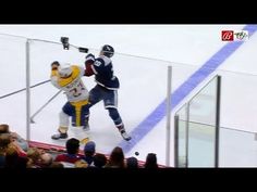 two men playing ice hockey in front of an audience