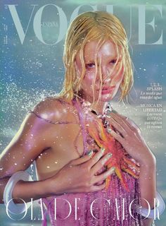 a magazine cover with a blonde woman in the water holding a starfish on her chest