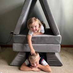 two children are playing in an inflatable bed with their arms around each other