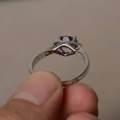 This is a gorgeous handmade creation. Its beauty is its simplicity & Elegance. The 5*7 mm oval shape faceted natural amethyst is crafted in solid sterling silver and with rhodium plated. All item is sent in a beautiful gift box If you have any idea of design your ring,pls contact me directly. You can realize more lovely stuff clicking the link https://www.etsy.com/shop/knightjewelry?refshopsection_shophome_leftnav Please leave the correct address and you phone number for delivering successfu Oval Amethyst Promise Ring Jewelry, Oval Amethyst Crystal Ring For Anniversary, White Gold Oval Amethyst Solitaire Ring, Oval White Gold Amethyst Solitaire Ring, Oval White Gold Amethyst Promise Ring, Oval Faceted Birthstone Ring For Anniversary, Oval Amethyst Rings With Accent Stones, Oval White Gold Solitaire Amethyst Ring, Purple Oval Crystal Ring With Prong Setting