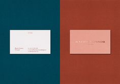 two business cards on top of each other, one in red and the other in blue