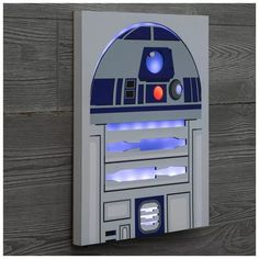 a star wars r2d2 light up wall plaque on a wood background with planks