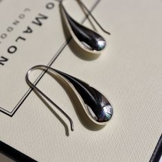 The silver liquid metal effect that gives them the appearance of a fresh raindrop is a unique and elegant that is sure to catch the eye. The contemporary design of the earrings with a teardrop shape and fixed hook drop setting makes them easy and fuss-free to wear, which is always a plus. The polished finish adds to their sleek and modern look, while the silver liquid metal effect gives them an organic and natural feel. these Sterling Silver liquid Drop Earrings are a beautiful and sophisticated Modern Metal Drop Earrings For Pierced Ears, Modern Teardrop Earrings For Gift, Polished Metal Drop Earrings, Metal Drop Earrings With Polished Finish, Modern Teardrop Earrings With Polished Finish, Modern Teardrop Drop Earrings For Everyday, Modern Drop Earrings For Pierced Ears, Hypoallergenic Modern Drop Earrings, Minimalist Metal Teardrop Drop Earrings