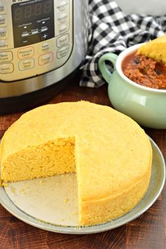 a cornbread cake with a slice missing from it and an instant pressure cooker in the background