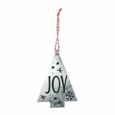 a christmas tree ornament with the word joy hanging from it's side