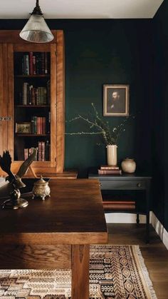 an open book sits on top of a wooden table in front of a bookshelf