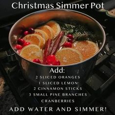 a pot filled with orange slices and cranberries