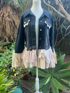 a mannequin wearing a denim jacket and lace skirt