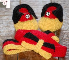 two knitted stuffed animals sitting on top of a wooden floor