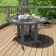 a table on a deck with food and drinks